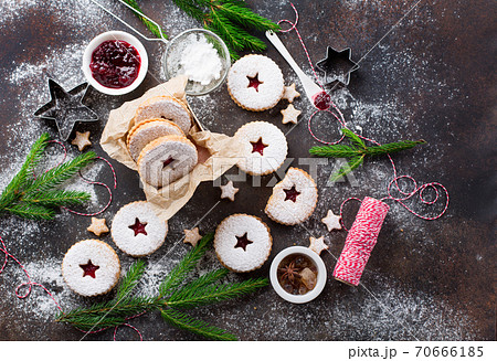 Traditional Christmas Linzer cookies with raspberry jam on dark background. 70666185