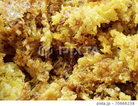 Drop of bee honey drip from hexagonal honeycombs 70666238