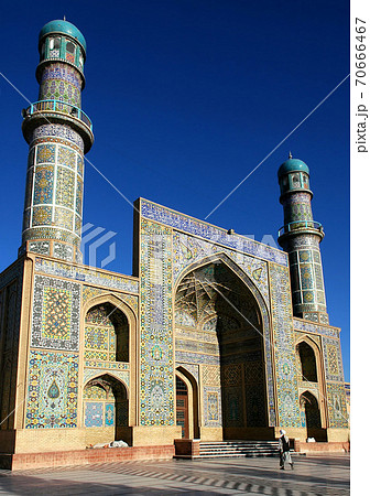 Herat in western Afghanistan. The Great Mosque of Herat (Friday Mosque or Jama Masjid). The mosque is decorated with mosaics and Quranic calligraphy. Friday Mosque with people in Herat, Afghanistan. 70666467