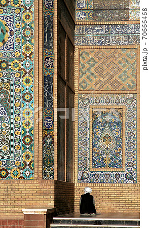 Herat in western Afghanistan. The Great Mosque of Herat (Friday Mosque or Jama Masjid). The mosque is decorated with mosaics and Quranic calligraphy. A man prays at the mosque in Herat, Afghanistan. 70666468