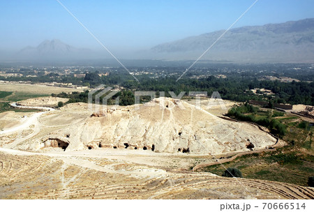 Takht-e Rostam (Takht-e Rustam) is a stupa monastery in northern Afghanistan. Looking down on the cave monastery from the stupa. Takht e Rostam is between Mazar i Sharif and Pol e Khomri, Afghanistan. 70666514