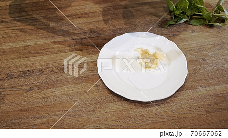 Cooked tortellini on white plate, wooden table close up 70667062