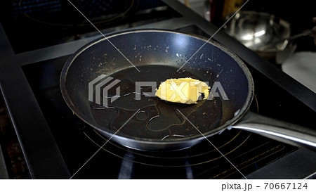Black pan with butter on hotplate in the restaurant Black pan with butter on hotplate in the restaurant 70667124