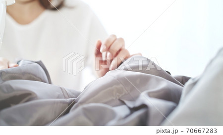 Female hands close up with grey material, sewing studio 70667283