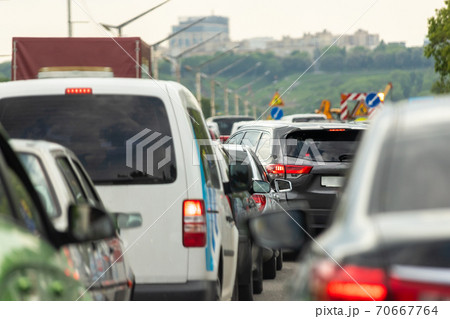 Highway interstate road with car traffic jam and Kiev on background. Motorway bumber barrier gridlock due country border control point. Vehicle crash accident and queue bottleneck on freeway Highway interstate road with car traffic jam and Kiev on background. Motorway bumber barrier gridlock due country border control point. Vehicle crash accident and queue bottleneck on freeway 70667764