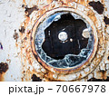 An old abandoned ship's porthole 70667978