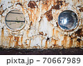 An old abandoned ship's porthole 70667989