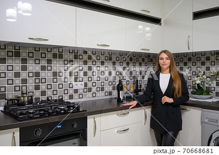 Young woman at luxury modern white kitchen interior in provence style 70668681