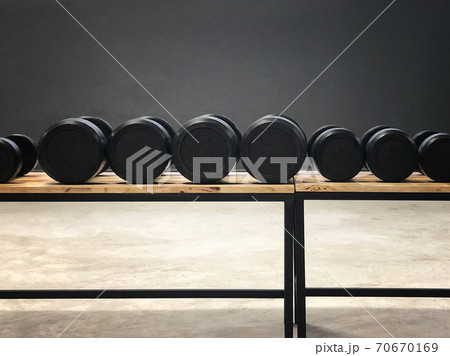 Black dumbbell set. Close up many metal dumbbells in sport fitness center Black dumbbell set. Close up many metal dumbbells in sport fitness center 70670169