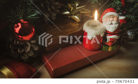 Santa Claus candle on wood table for Christmas content. Santa Claus candle on wood table for Christmas content. 70670431