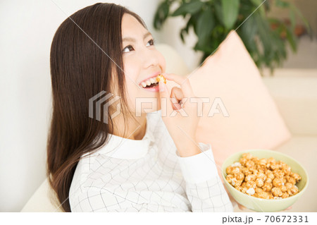 ポップコーンを食べる女性 70672331