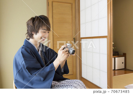 デジタルカメラを見る男性 70673485