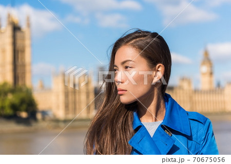 Travel London woman at Westminster, Big Ben, famous holiday destination. Autumn travel lifestyle. Asian girl portrait wearing blue trench coat in urban city 70675056