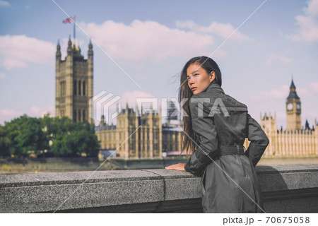 London trench coat business woman at Westminster. Fashion businesswoman in grey raincoat. Asian beauty model outdoor 70675058