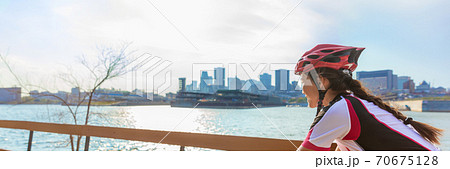 Biking woman ridig city bike panoramic banner landscape -Cyclist girl in summer outdoor background Biking woman ridig city bike panoramic banner landscape -Cyclist girl in summer outdoor background 70675128