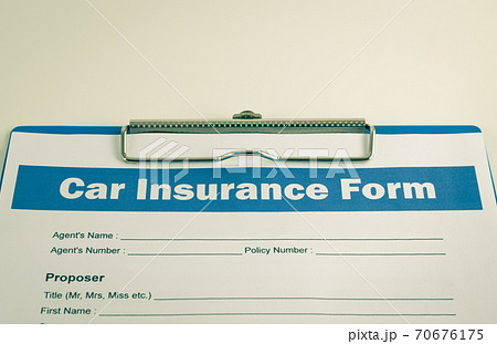 Car Insurance Claim Form or Insurance Document on Clipboard in Vintage Tone 70676175