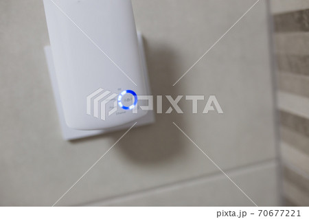 Wifi home repeater plugged in closeup. 70677221