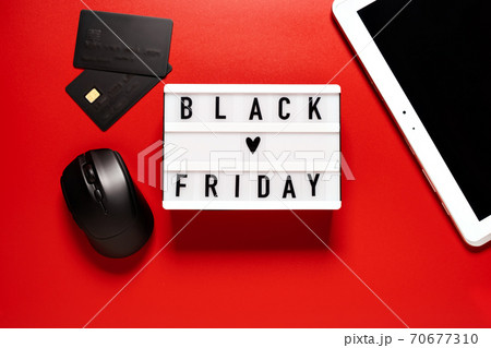 Black friday sale word on lightbox on a red background Black friday sale word on lightbox on a red background 70677310