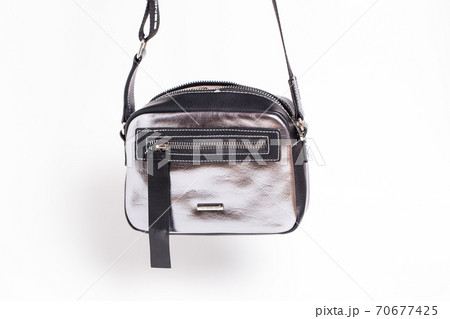 Silver ladies handbag with black accents on a white background. Silver ladies handbag with black accents on a white background. 70677425