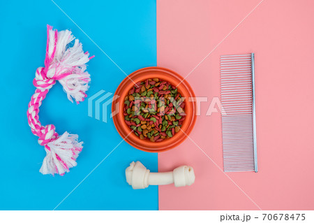 Dry food in bowls with bone, toy, for pets on color background 70678475