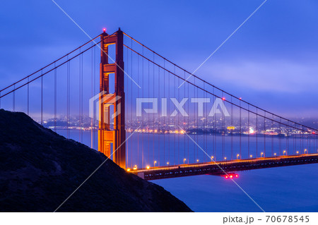 Golden gate with blue overcast sky at dawn. 70678545