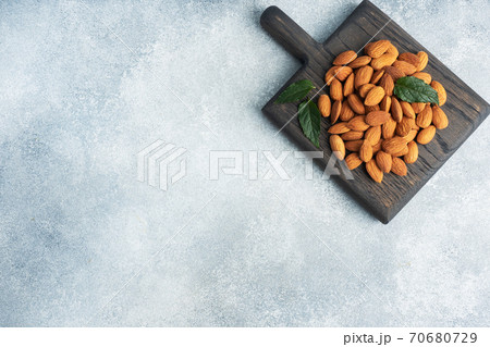 Peeled almonds on a wooden rustic background. Copy space. 70680729