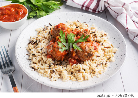 Beef meatballs and brown rice on a plate. Ready made portioned dish meat with garnish. Beef meatballs and brown rice on a plate. Ready made portioned dish meat with garnish. 70680746