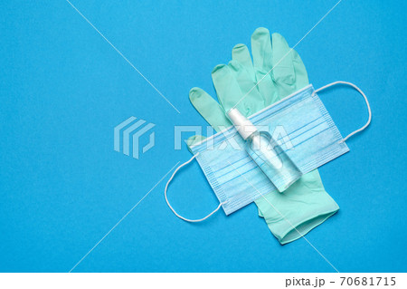 Safety equipment to fight to Coronavirus COVID-19 virus outbreak - Safety mask, hand sanitizer, latex gloves and protective glasses or goggles 70681715