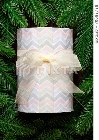 Top view of festive gift box decorated with green fir tree branches. Christmas time with copy space 70683738