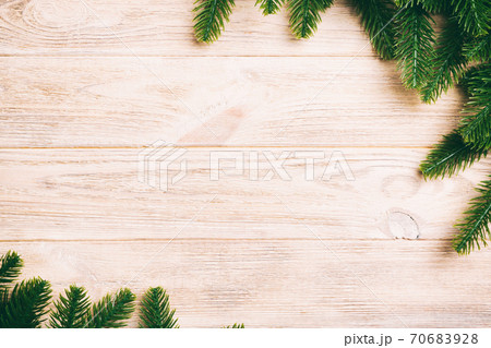 Top view of frame made of fir tree branches on wooden background. Christmas concept with empty space for your design 70683928