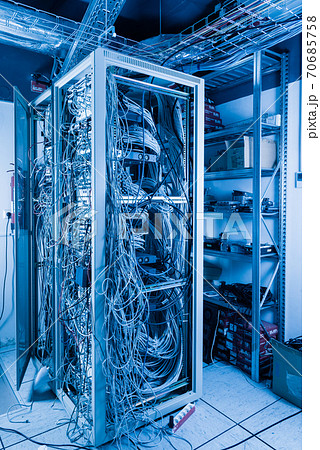 server room rack with tangled network cables creating messy unti 70685758