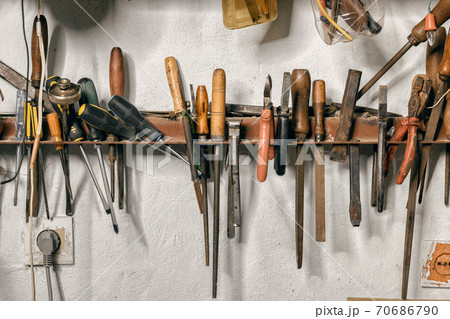 Variety of old vintage and modern household hand tools on a garage shelves in a DIY and renovations concept Variety of old vintage and modern household hand tools on a garage shelves in a DIY and renovations concept 70686790