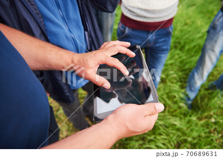 Agronomist Using a Tablet for read a report on the agriculture Field with copy space and vintage tone with selective focus,agriculture technology concept for a industrial 70689631