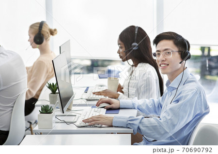 Group of positive technical support managers working on hotline at call centre 70690792