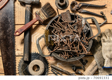Old vintage household hand tools still life on a wooden background in a DIY and repair concept Old vintage household hand tools still life on a wooden background in a DIY and repair concept 70691331