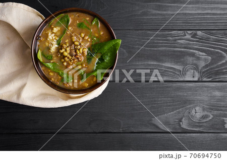 Spinach Mung Dhal and Chapati on black wooden table top. Moong Dal - Indian Cuisine curry. 70694750