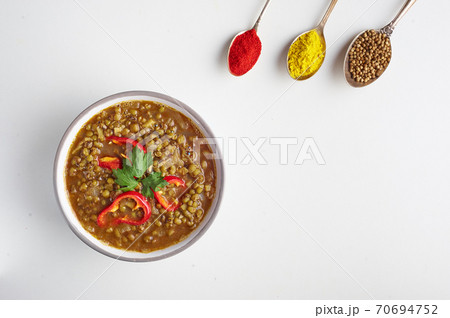 Mung Dhal isolated on white. Moong Dal - Indian Cuisine curry. Mung Dhal isolated on white. Moong Dal - Indian Cuisine curry. 70694752