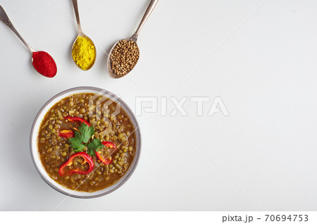 Mung Dhal isolated on white. Moong Dal - Indian Cuisine curry. Mung Dhal isolated on white. Moong Dal - Indian Cuisine curry. 70694753