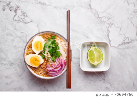 Mohinga or Burmese Fish Noodle Soup on white marble background. 70694766