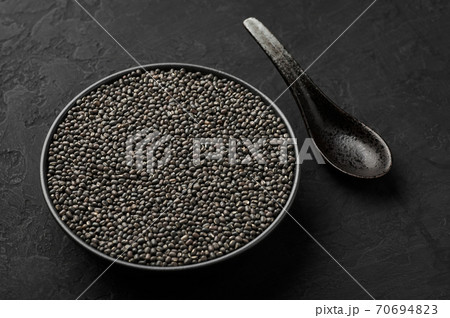 Black Gram or Urad Beans or Mung Beans in bowl on dark slate table top. Vigna Mungo is popular indian cuisine food Black Gram or Urad Beans or Mung Beans in bowl on dark slate table top. Vigna Mungo is popular indian cuisine food 70694823