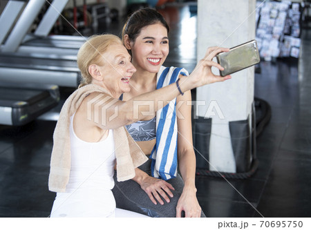 Couple attractive women smiling taking a selfie 70695750