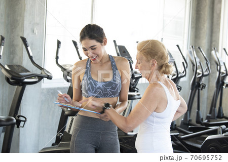 Instructor with senior woman in rehabilitation  70695752