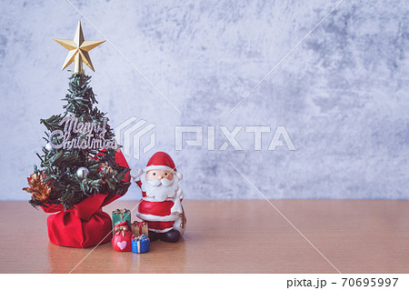 Christmas decoration - Santa Clause, tree and gift on wooden table. Christmas and Happy new year concept 70695997