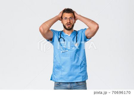 Healthcare workers, medicine, covid-19 and pandemic self-quarantine concept. Concerned and shocked, worried nurse, doctor grab head and gasping anxious, listening bad news, got in trouble 70696170