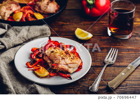 Baked chicken thighs with red bell peppers and lemon Baked chicken thighs with red bell peppers and lemon 70696447