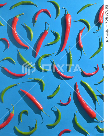 Red and Greeen Chili Peppers over blue background 70697698