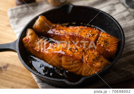 cooked salmon teriyaki on skillet pan 70698002