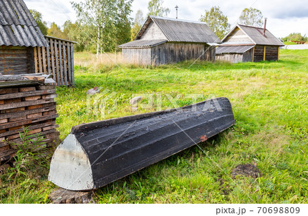 Old wooden fishing boat at the bank of the lake 70698809