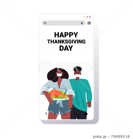 man woman in masks celebrating happy thanksgiving day african american couple holding roasted turkey coronavirus man woman in masks celebrating happy thanksgiving day african american couple holding roasted turkey coronavirus 70699516