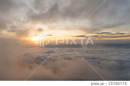 Aerial view of sunset above fluffy sea fog misty clouds with mountain hill from Phu Tub Berk, Khao Kho, Phetchabun with sunlight. Abstract nature landscape background at twilight time. Aerial view of sunset above fluffy sea fog misty clouds with mountain hill from Phu Tub Berk, Khao Kho, Phetchabun with sunlight. Abstract nature landscape background at twilight time. 70700770